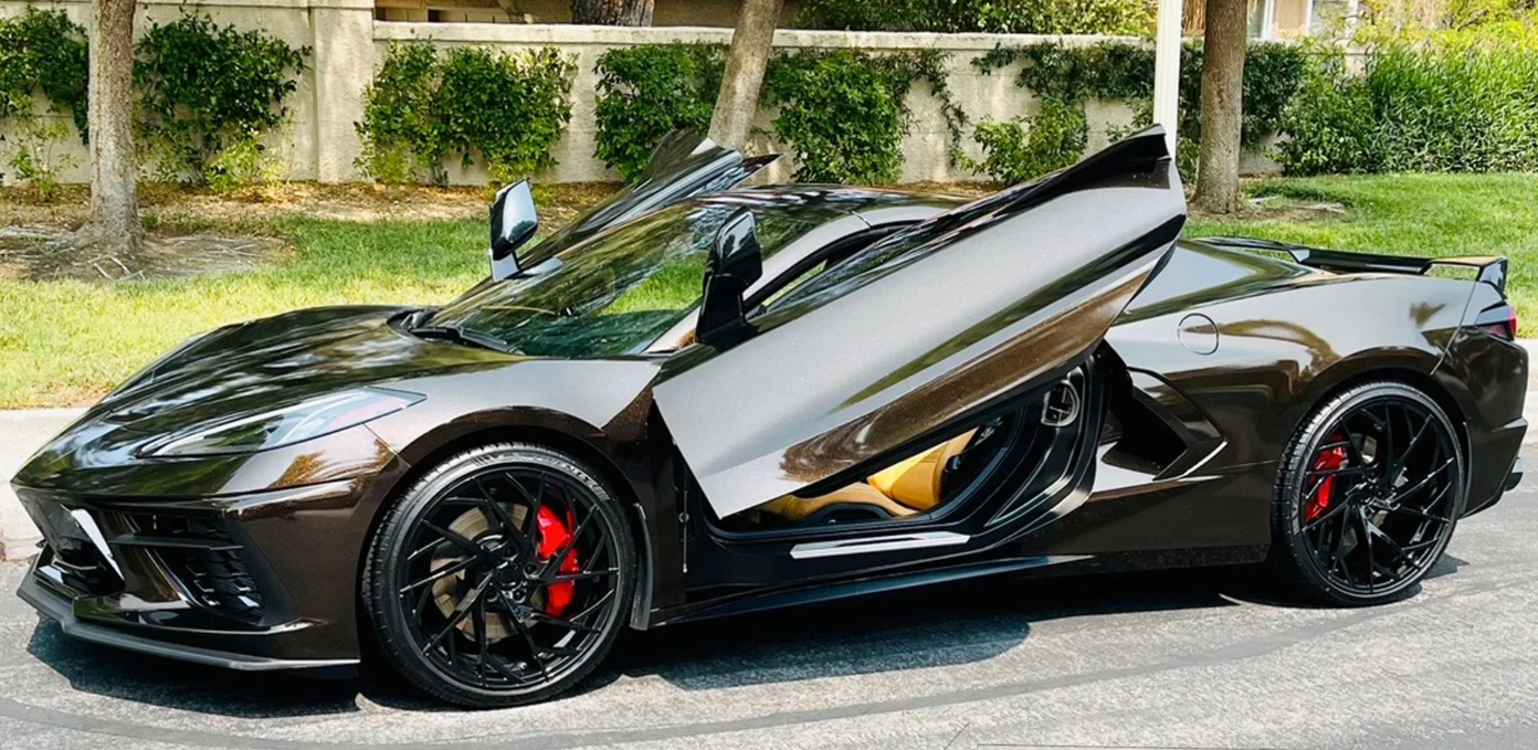 Black C8 Corvette with C8 Corvette butterfly door kit installed showing open butterfly doors and red brake calipers