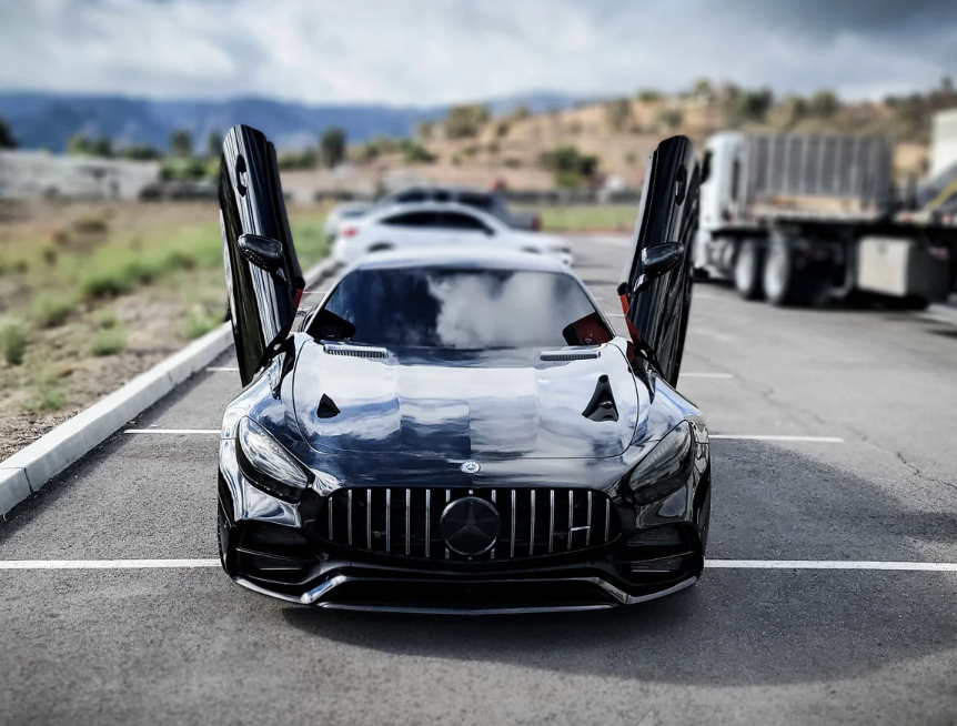 Black Mercedes AMG GT with vertical lambo doors kit installed by Vertical Doors Inc in parking lot