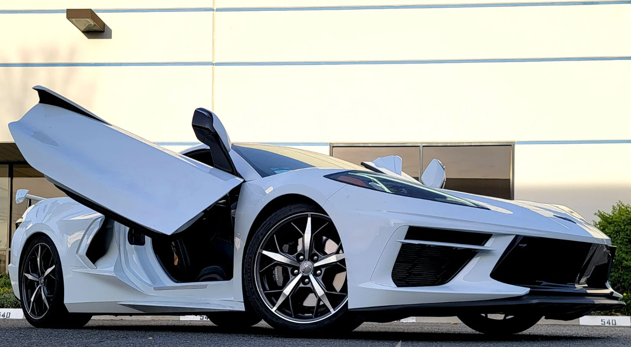 White C8 Corvette with C8 Corvette butterfly door kit installed showing open butterfly doors