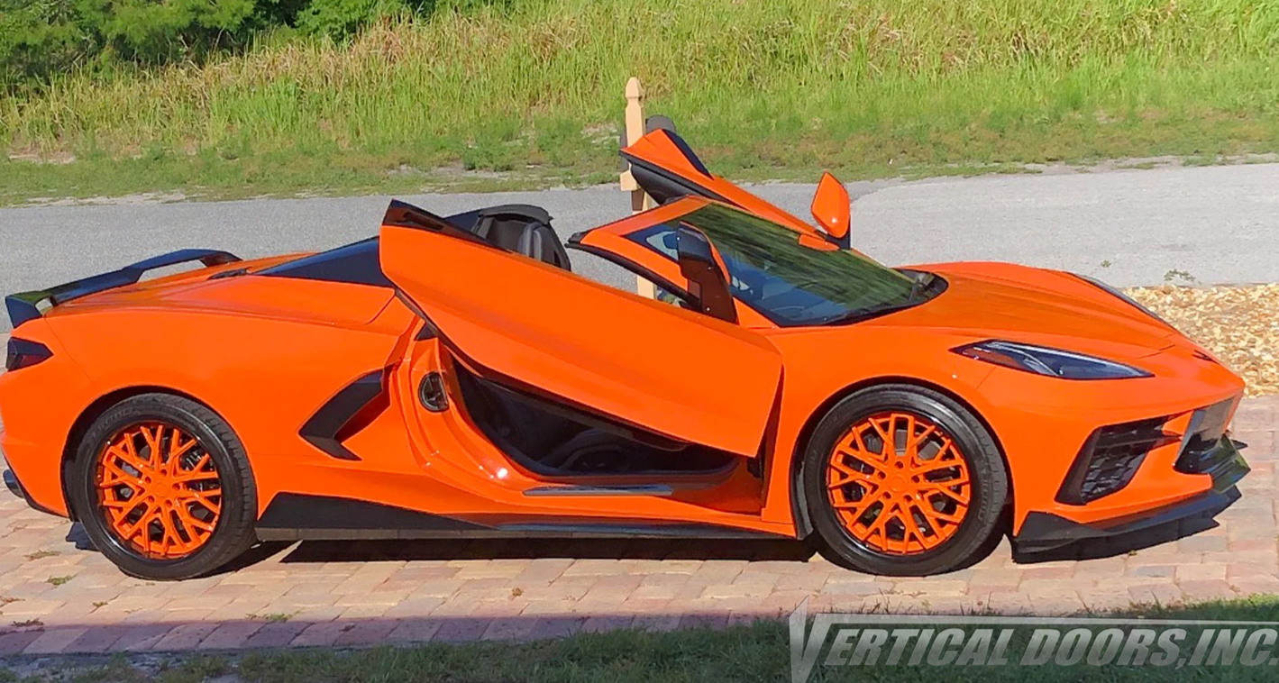 Orange C8 Corvette with aftermarket butterfly doors open showcasing C8 Corvette butterfly door kit by Vertical Doors Inc
