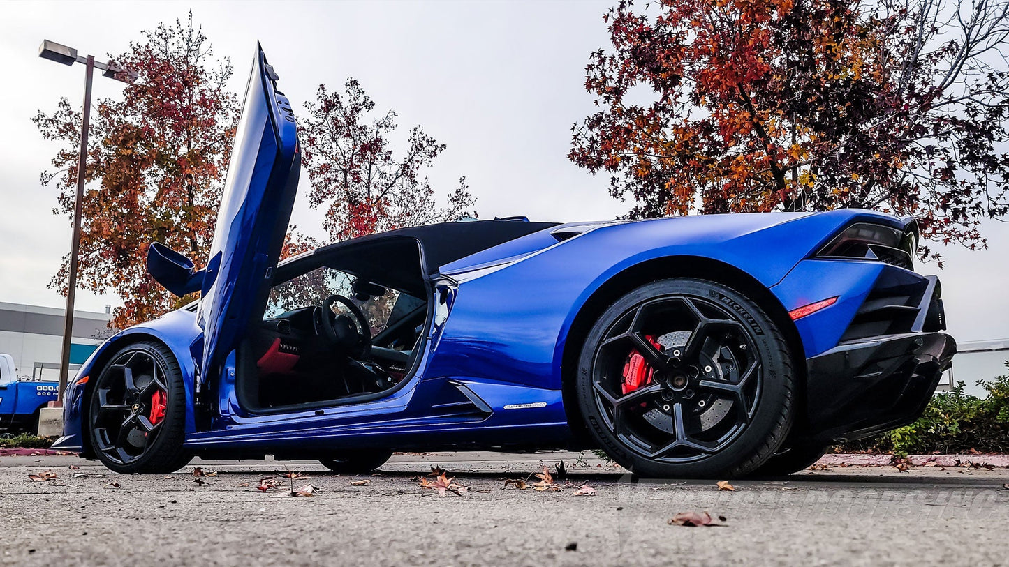 Blue Lamborghini Huracan with Vertical Doors Inc Lambo door kit for Lamborghini Huracan fully opened on a street