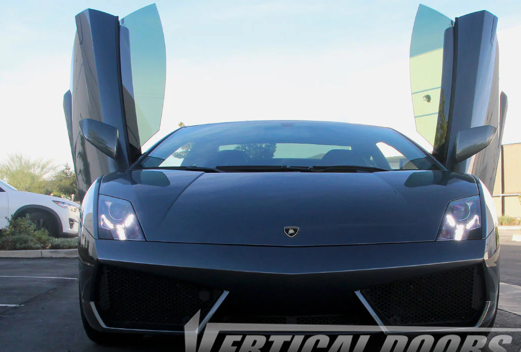 Black Lamborghini with Gallardo Lambo doors kit installed showing vertical door lift in outdoor setting