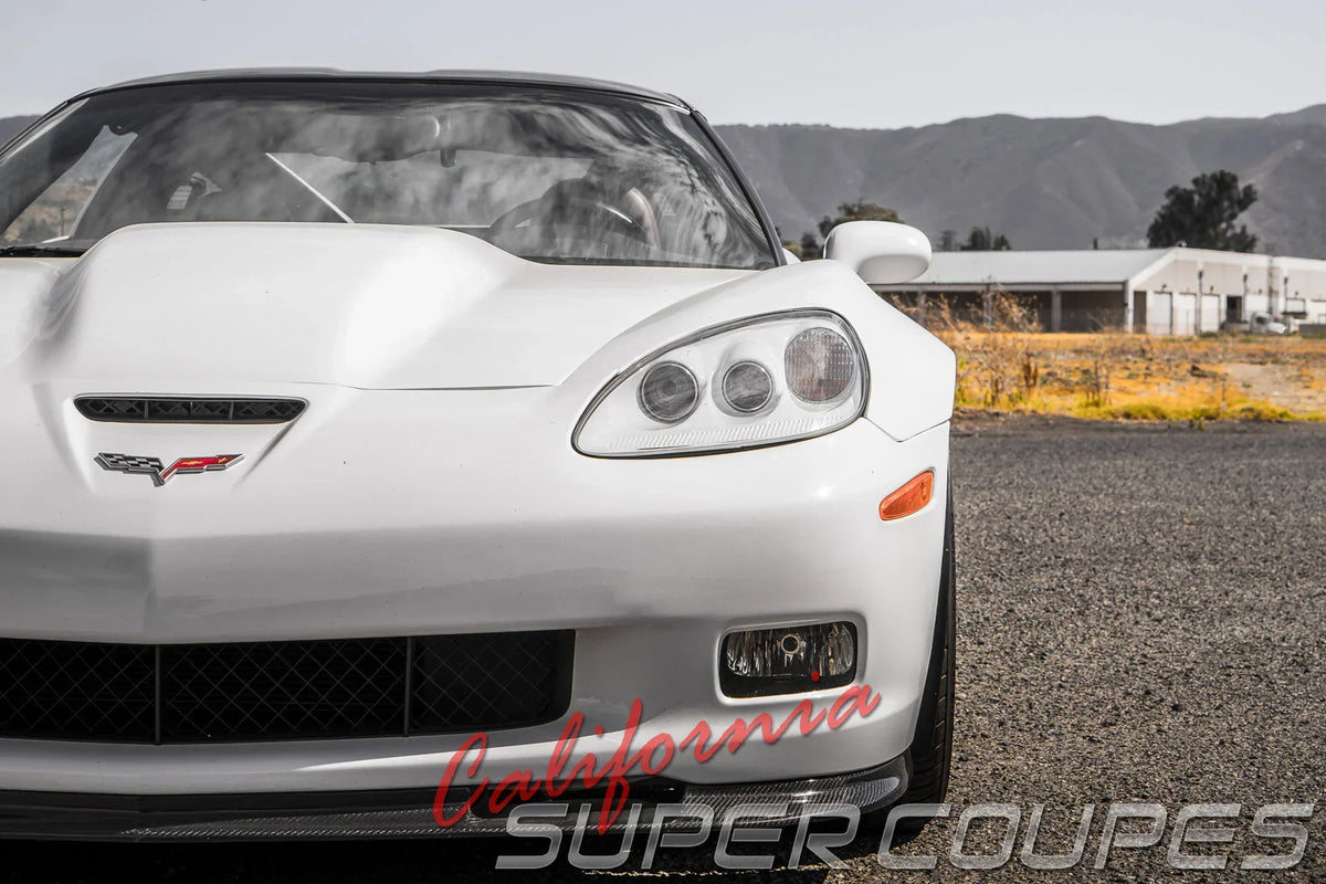 White Corvette C6 front view featuring California Super Coupes Corvette C6 wide body fenders in outdoor setting