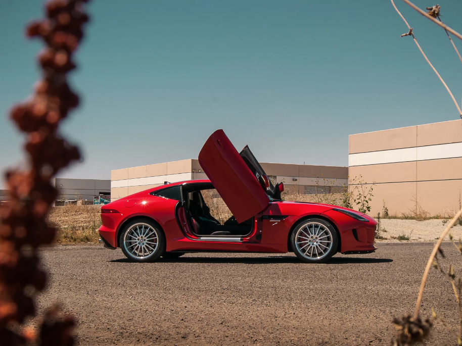 Red Jaguar F-Type with Jaguar F-Type Lambo doors kit installed shown in open position