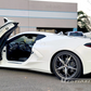 White C8 Corvette with C8 Corvette butterfly door kit installed, showing open butterfly doors