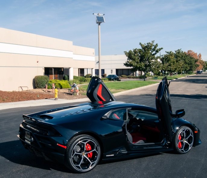 Black Lamborghini with Huracan Lambo door kit installed showing both doors open upwards by Vertical Doors Inc