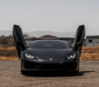 Black Lamborghini with open Huracan Lambo door kit in outdoor setting by Vertical Doors Inc