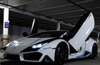 White Lamborghini with open Huracan Lambo door kit installed in a parking garage